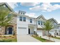 Attractive townhouse exteriors with diverse siding, lawns, driveways, and blue sky background at 43 Honeydew Way, Clayton, NC 27520