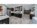 Bright modern kitchen features stainless appliances, white countertops, black cabinets and eat in area at 5705 Katha Dr, Holly Springs, NC 27540