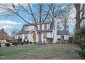 Two-story house with a gambrel roof, landscaping, and walkway at 808 W Willowbrook Dr, Burlington, NC 27215