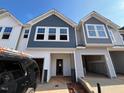 New construction townhome with inviting covered entrance and attached garages at 259 Whitley Ridge Dr # 247, Clayton, NC 27527
