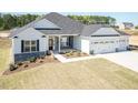 Charming home with a three-car garage, stone accents, and well-maintained landscaping at 534 Glenkirk Pl # 110, Garner, NC 27529