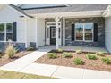 Inviting front porch with stone accents, manicured landscaping, and a well-lit entrance at 534 Glenkirk Pl # 110, Garner, NC 27529