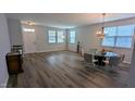 Bright dining area with lots of windows, chandelier and hardwood floors at 101 Clardona Way, Holly Springs, NC 27540