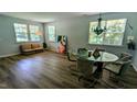 Bright living room with hardwood floors, large windows, and modern decor at 101 Clardona Way, Holly Springs, NC 27540