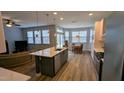 Open concept living space with dining area, stainless steel appliances and a cozy couch at 101 Clardona Way, Holly Springs, NC 27540