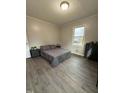 This staged bedroom features plank flooring, paint, and decor at 1118 Jackson St, Burlington, NC 27217