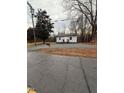 Charming one-story home with freshly graveled yard and covered front porch at 1118 Jackson St, Burlington, NC 27217