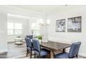 Bright dining area with a built-in bench and a chandelier at 1319 Hollyview Ave, Durham, NC 27703