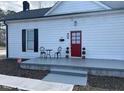 Charming home with a bright red front door and a cozy porch area at 334 E Andrews Ave, Henderson, NC 27536