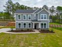 Charming two-story home with a well-manicured lawn and beautiful landscaping at 367 Duncan Creek Rd # 129, Lillington, NC 27546