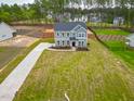 Expansive front yard featuring a long driveway and lush green lawn at 367 Duncan Creek Rd # 129, Lillington, NC 27546