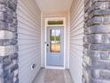 Inviting front door of the home, framed by stone accents and light-colored siding at 403 Duncan Creek Rd # 131, Lillington, NC 27546