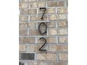 Close-up of the address '702' displayed on a textured brick wall of a residential property at 702 Portia Way, Homesite 16, Morrisville, NC 27560