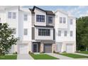 New construction townhome featuring a brick facade, a gray garage door, and manicured landscaping at 702 Portia Way, Homesite 16, Morrisville, NC 27560