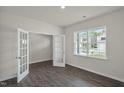 A spacious living room with light gray wood-look floors and plenty of natural light at 1128 Middlecrest Dr, Rocky Mount, NC 27804