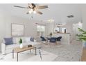 Open-concept living space with white sofa, stylish marble floors, and seamless flow to the dining area at 2248 Ventana Ln, Raleigh, NC 27604