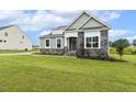 Lovely home showcasing green grass and stone details at 261 Kissington Way, Benson, NC 27504