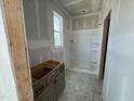 New bathroom construction features a shower and an unfinished vanity, with a window providing natural light at 303 Chesapeake Cmns St # 99, Garner, NC 27529