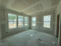 Bright living room with multiple windows offering views of the neighborhood at 303 Chesapeake Cmns St # 99, Garner, NC 27529