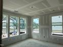 Unfinished living room featuring a spacious area with multiple windows overlooking the neighborhood at 303 Chesapeake Cmns St # 99, Garner, NC 27529