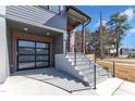 View of a garage, featuring an aluminum and translucent glass door, and gray stone steps at 1000 Addison Pl # 101, Raleigh, NC 27610
