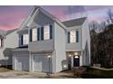 Charming two-story home features a garage and blue shutters for a classic look at dusk at 1212 Southgate Dr, Raleigh, NC 27610