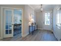 Bright entryway with French doors to an office, a white front door, light wood floors, and modern decor at 167 Logbridge Rd, Chapel Hill, NC 27516