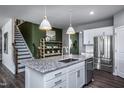 Spacious kitchen with white cabinets, granite island, and stainless steel appliances at 764 Denburn Pl, Raleigh, NC 27603