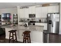 Modern kitchen with white cabinets, granite counters, and island at 5200 Stream Stone Way, Raleigh, NC 27616