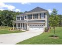 Charming two-story home featuring brick and vinyl, an attached two-car garage, and an inviting front yard at 55 New Liberty Dr, Youngsville, NC 27596