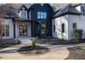 Elegant front entrance with a stone walkway and modern black and white design at 6701 Green Hollow Ct, Wake Forest, NC 27587