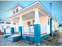 Craftsman style home with a wraparound porch and teal colored brick at 716 S Tillery St, Rocky Mount, NC 27803