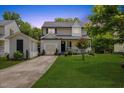 Charming two-story home with a well-manicured lawn and a detached garage at twilight at 4708 River Boat Landing Ct, Raleigh, NC 27604