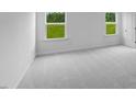 Light and airy bedroom with soft gray carpet and bright windows overlooking a green lawn at 630 Contento Ct, Sanford, NC 27330