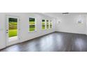 Open-concept living room with hardwood floors, white walls, a door to the back yard, and lots of natural light at 630 Contento Ct, Sanford, NC 27330