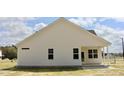 Rear view of a home showcasing the home's siding, windows, and covered back porch at 79 Surles Landing Way, Benson, NC 27504