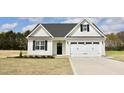 Charming new construction home featuring white siding, black accents, and an attached two-car garage at 79 Surles Landing Way, Benson, NC 27504