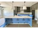 Island kitchen with white countertops and stainless steel appliances at 130 Broadleaf Ln, Youngsville, NC 27596