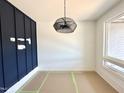 Bright room with a modern light fixture and navy accent wall at 130 Broadleaf Ln, Youngsville, NC 27596