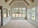 Dining area showcases a large picture window, vaulted ceiling, and modern light fixture at 135 Cherry Bark Dr, Youngsville, NC 27596