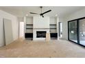 Open living room with a fireplace, built-in shelves, and a sliding glass door at 135 Cherry Bark Dr, Youngsville, NC 27596