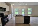 Modern kitchen with granite countertops, stainless steel appliances, and a functional island at 163 Vili Dr, Broadway, NC 27505