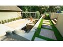 A private backyard oasis featuring a stone patio, water feature, and meticulously landscaped garden, creating a serene outdoor retreat at 2213 Weybridge Dr, Raleigh, NC 27615