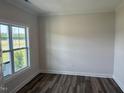 Bright room featuring a double window providing natural light and wood-look flooring at 23 Surles Landing Way, Benson, NC 27504