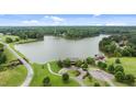 Stunning aerial view of lakefront home, lush greenery, and manicured lawns at 30 Hidden Lake Dr, Franklinton, NC 27525