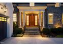 Close-up of the front door entrance framed by white columns, stonework, and manicured landscaping at 1307 Mayfair Rd, Raleigh, NC 27608