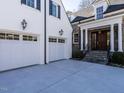 Two-car garage with white doors and lanterns, attached to the home at 1307 Mayfair Rd, Raleigh, NC 27608