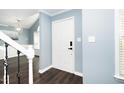 Bright entryway with hardwood floors and white door at 1554 Middle Ridge Dr, Willow Springs, NC 27592
