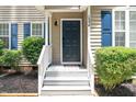 Inviting front entry with blue door and white railings at 1554 Middle Ridge Dr, Willow Springs, NC 27592