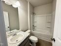 Well-lit bathroom with a shower-tub combo, tile floors, and single sink vanity create a functional space at 162 Vega Loop, Sanford, NC 27330
